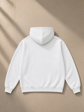 Unisex oversize heavyweight fleece hoodie in Lucent White, laid flat on pale limestone, back view