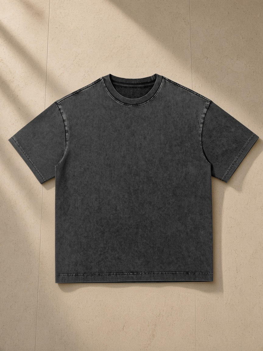 Snow Washed Heavyweight Oversize T-Shirt in Black, laid flat on pale limestone