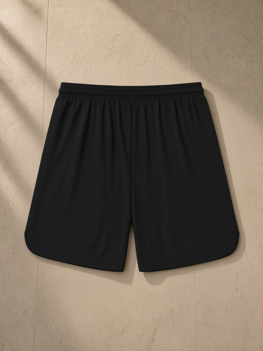 Mesh-Lined Quick-Dry Performance Shorts in Black, laid flat on pale limestone, back.