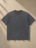 Mineral Wash Oversized T-Shirt in Charcoal Gray, laid flat on pale limestone, front view