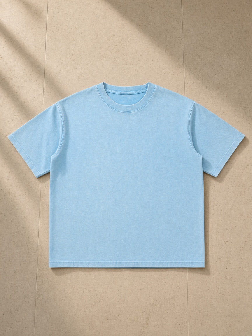 Unisex mineral wash boxy cotton t-shirt in Sky Blue, laid flat on pale limestone
