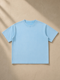 Unisex mineral wash boxy cotton t-shirt in Sky Blue, laid flat on pale limestone