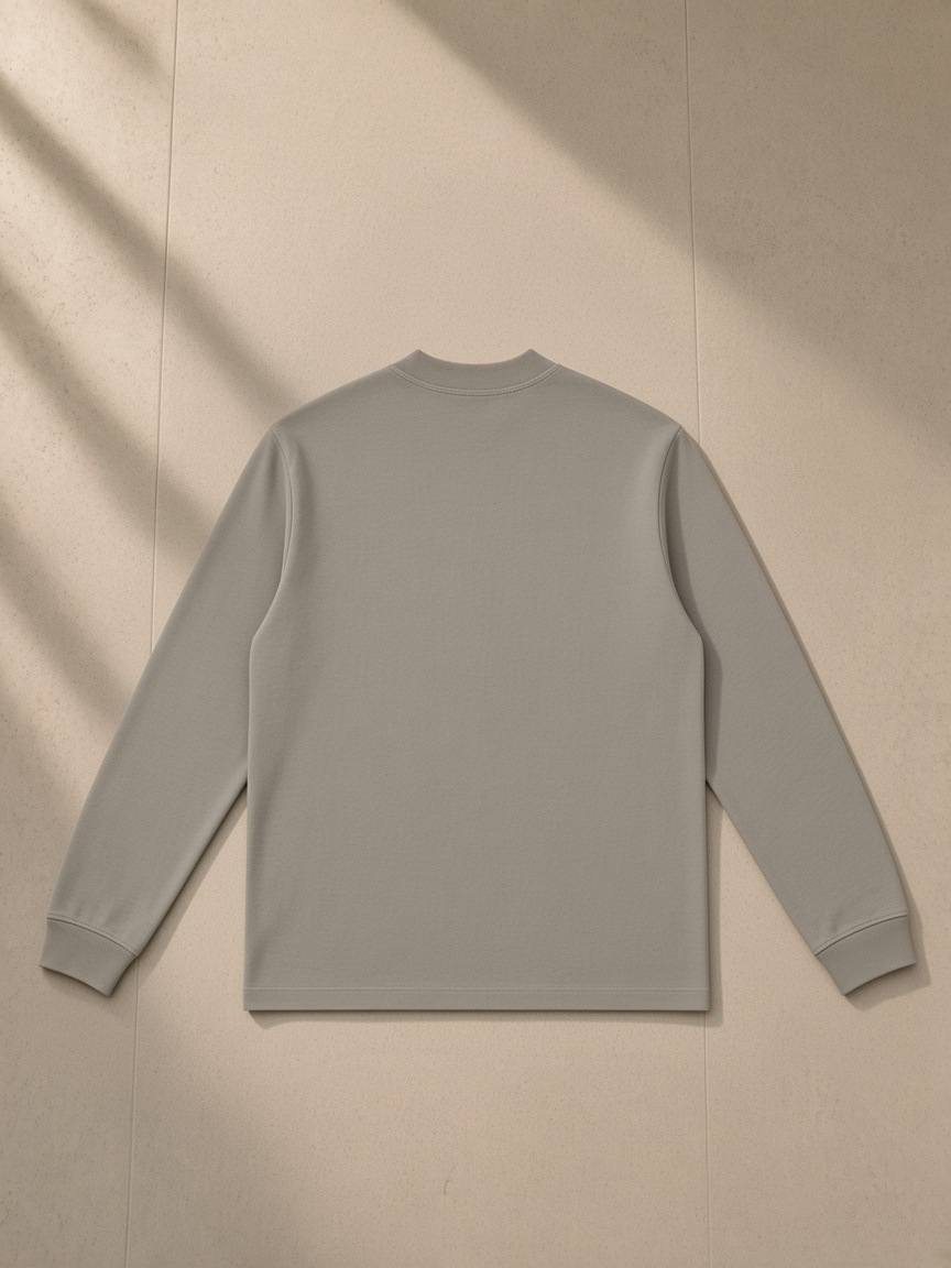 Non-shrink mock neck sweatshirt in Dark Apricot, laid flat on pale limestone, back view