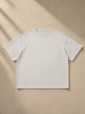 Vintage Washed Distressed Boxy Oversized T-Shirt in Pale Khaki, laid flat on pale limestone
