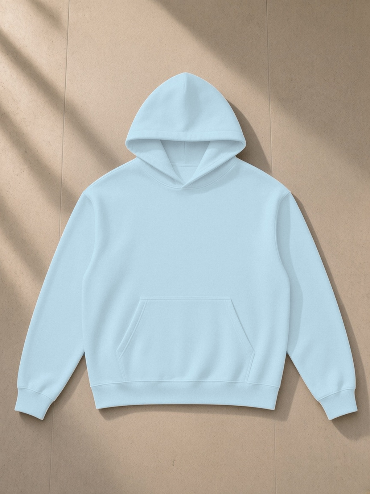 Essential Heavyweight Drop-Shoulder Hoodie in Sky Blue, laid flat on pale limestone, front.