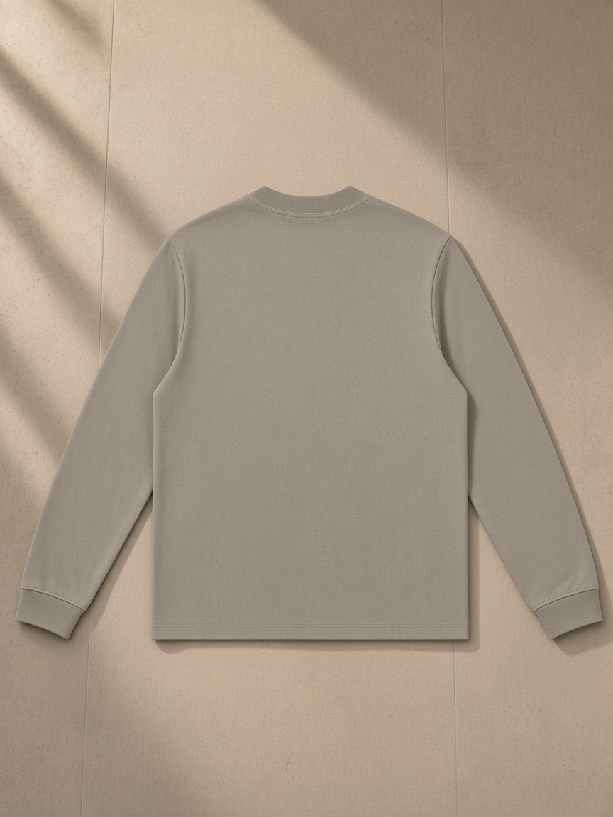 Mock Neck Sweatshirt in Dark Apricot, laid flat on pale limestone, back view