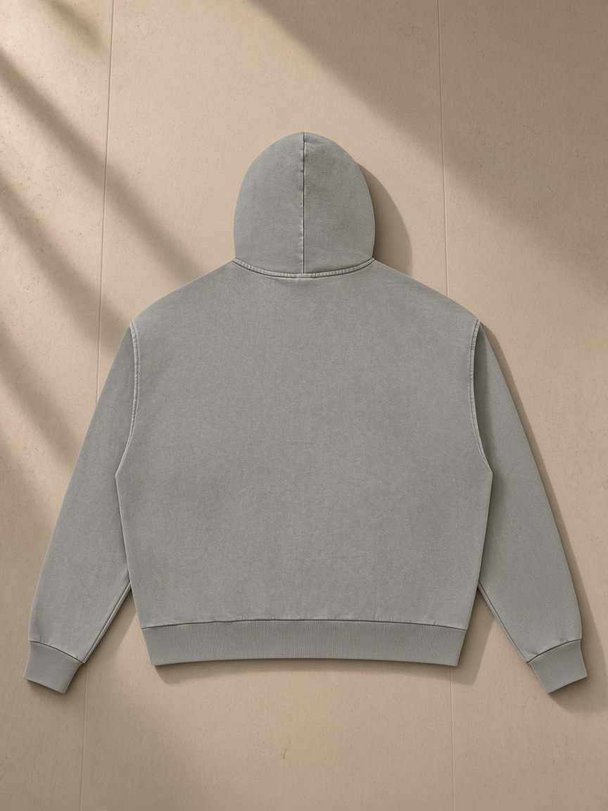 Mineral Wash Boxy Full Zip Hoodie in Light Gray, laid flat on pale limestone, back view