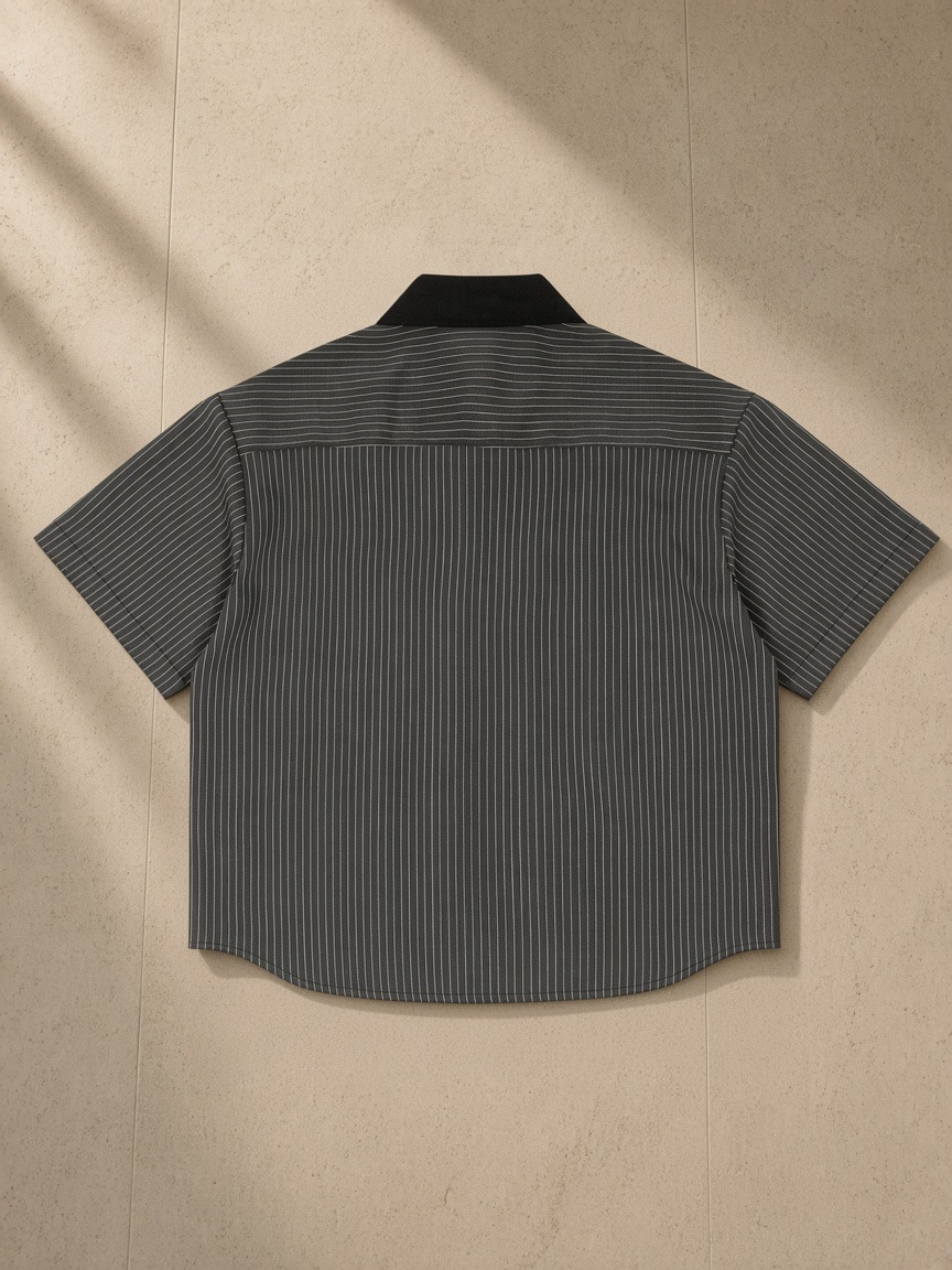 Striped Boxy Contrast Collar Shirt in Dark Gray, laid flat on pale limestone, back view
