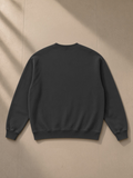 Vintage wash fleece sweatshirt in Black, laid flat on pale limestone, back view