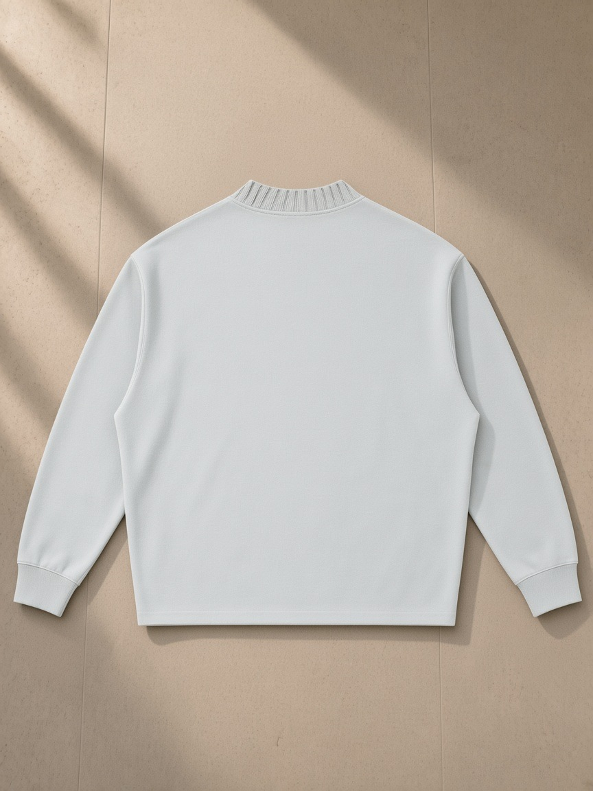 Unisex knitted round neck oversize sweatshirt in Light Gray, laid flat on pale limestone, back view
