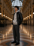Man in the Fleece Regular Shoulder Hoodie in Flower Gray under a black leather jacket, in the Galleria Vittorio Emanuele in Milan at night