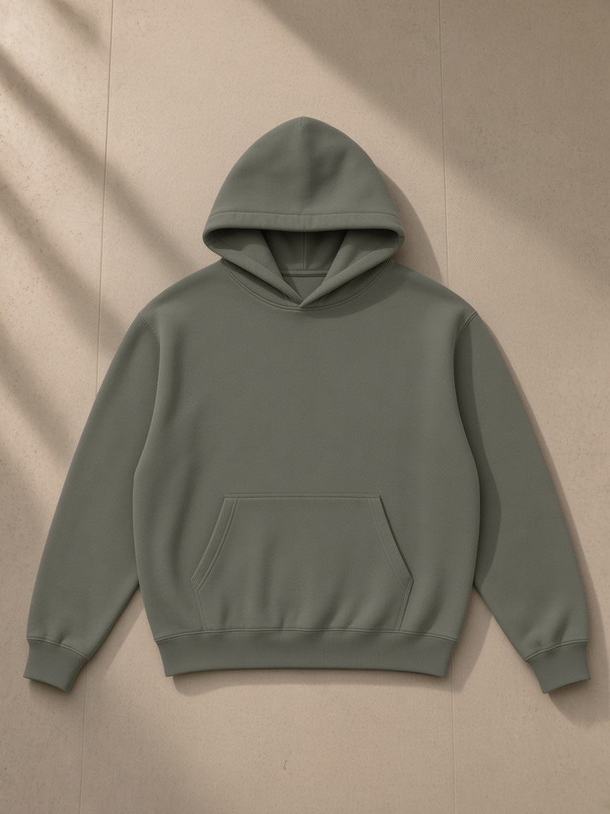 Fleeced boxy hoodie in Dark Gray, laid flat on pale limestone, front view