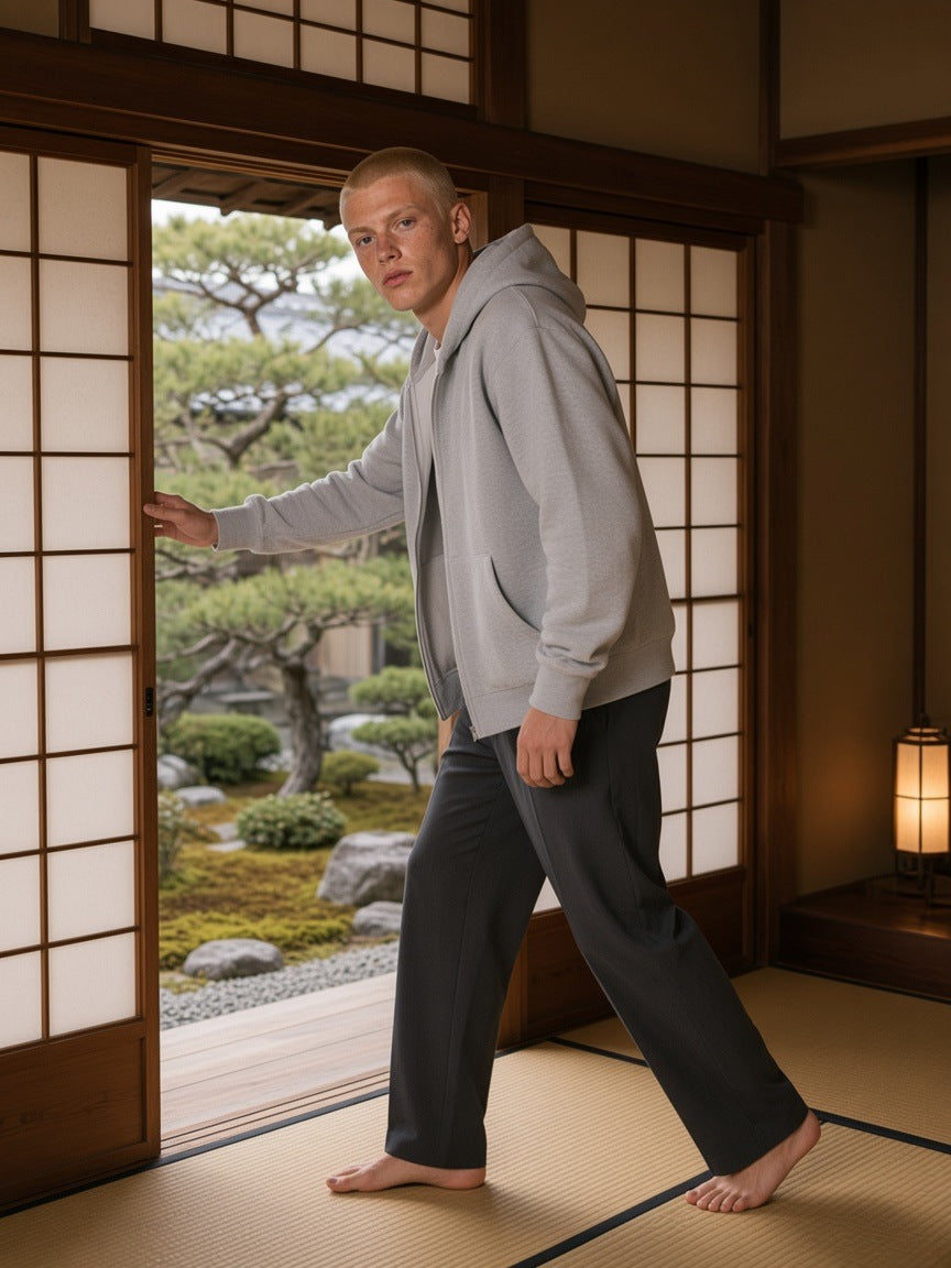Man in the Fleeced Full-Zip Boxy Hoodie in Flower Gray over a white tee, barefoot in a ryokan suite in Kyoto in the morning
