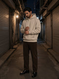 Man in the Fleeced High Neck Hoodie in Oat Gray with brown corduroy trousers and Chelsea boots, in a print-shop lane in Euljiro, Seoul at night