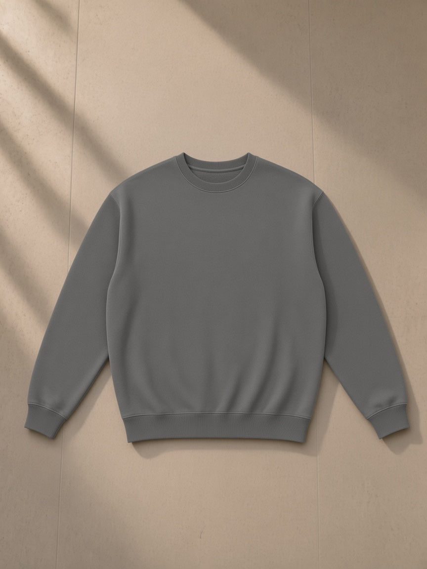 Fleeced sweatshirt in Gray, laid flat on pale limestone, front view