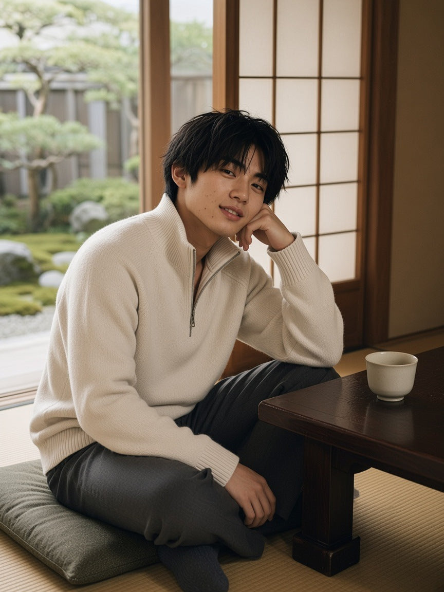 Man in the Heavyweight Collared Quarter-Zip in Beige, at a low table by a moss garden in a Kyoto ryokan in the morning