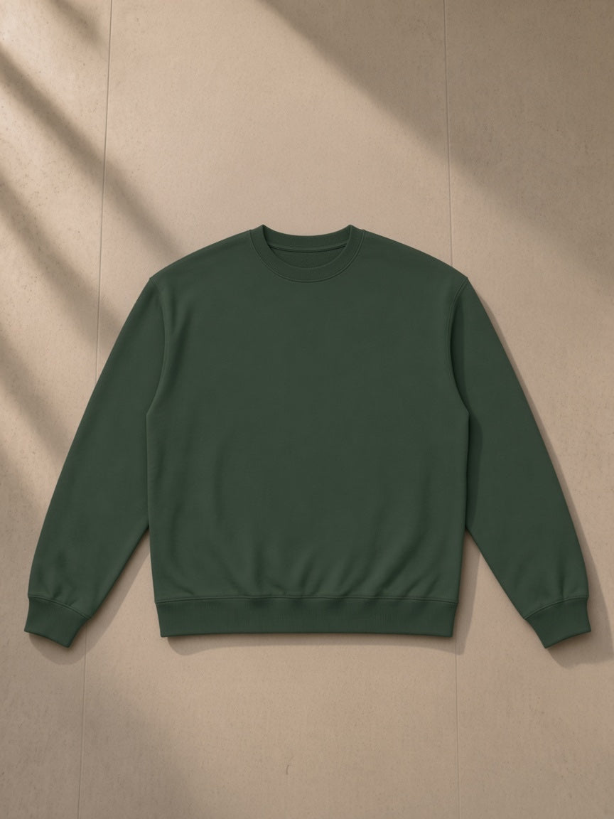 Heavyweight Crewneck Sweatshirt in Blackish Green, laid flat on pale limestone, front view
