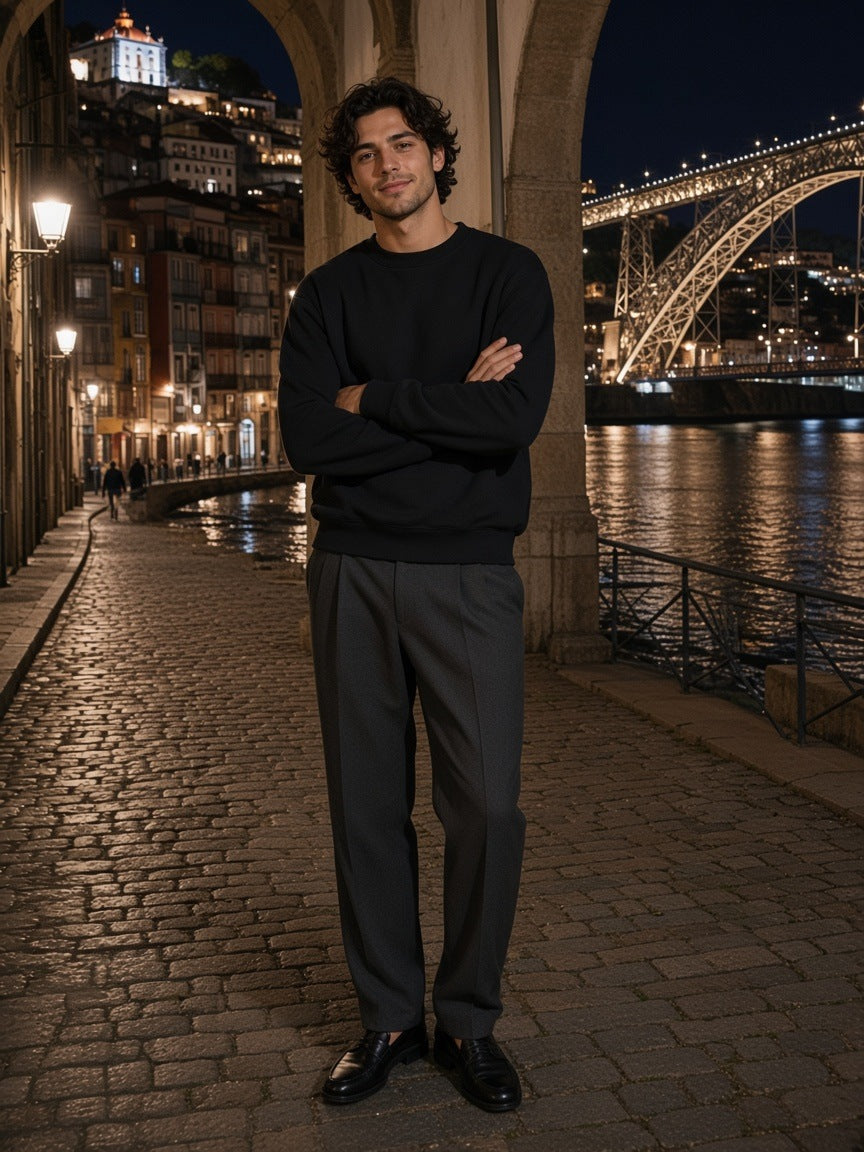 Man in the Marcel Afters Heavyweight Drop Shoulder Sweatshirt in Black Beauty with charcoal trousers and loafers, in a lantern-lit stone alley in Aoyama, Tokyo at night