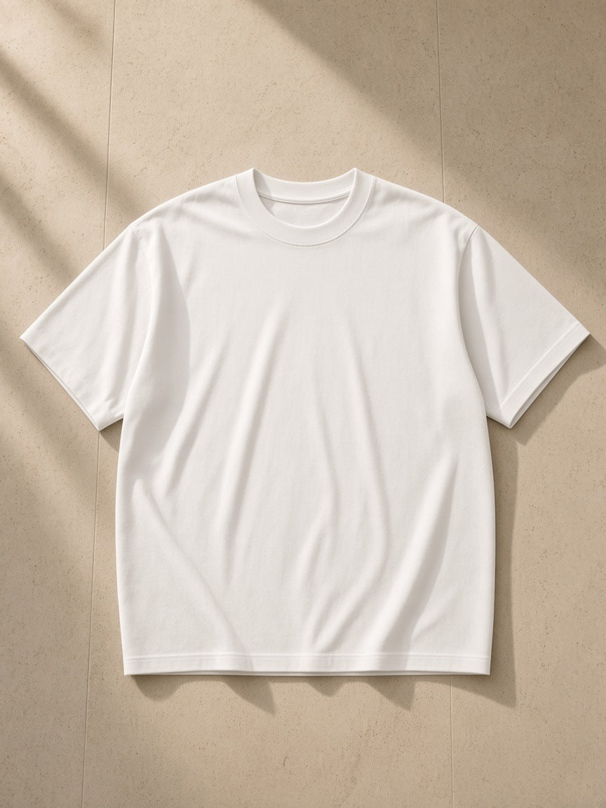 Heavyweight Drop Shoulder T-Shirt in White, laid flat on pale limestone