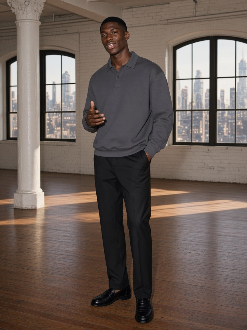 Man in the heavyweight fleece polo sweatshirt in Charcoal Gray standing in a Tribeca loft in New York by day