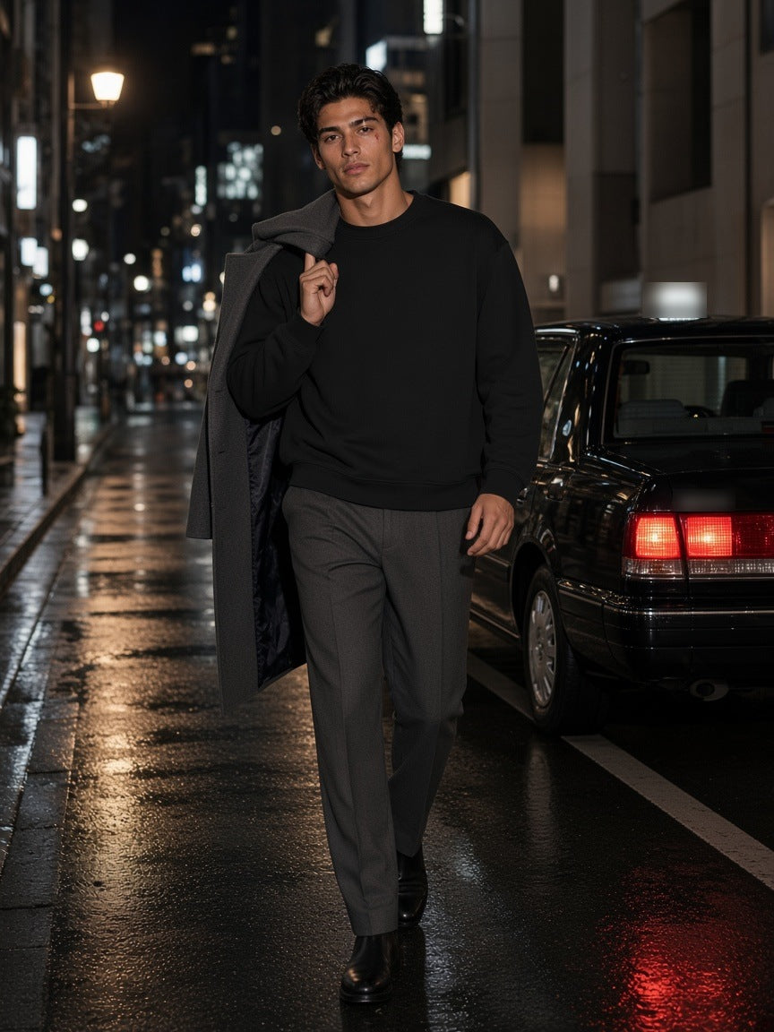 Man in the Heavyweight Oversized Boxy Sweatshirt in Black with stone-grey trousers and Chelsea boots, walking a rain-wet Ginza side street in Tokyo at night