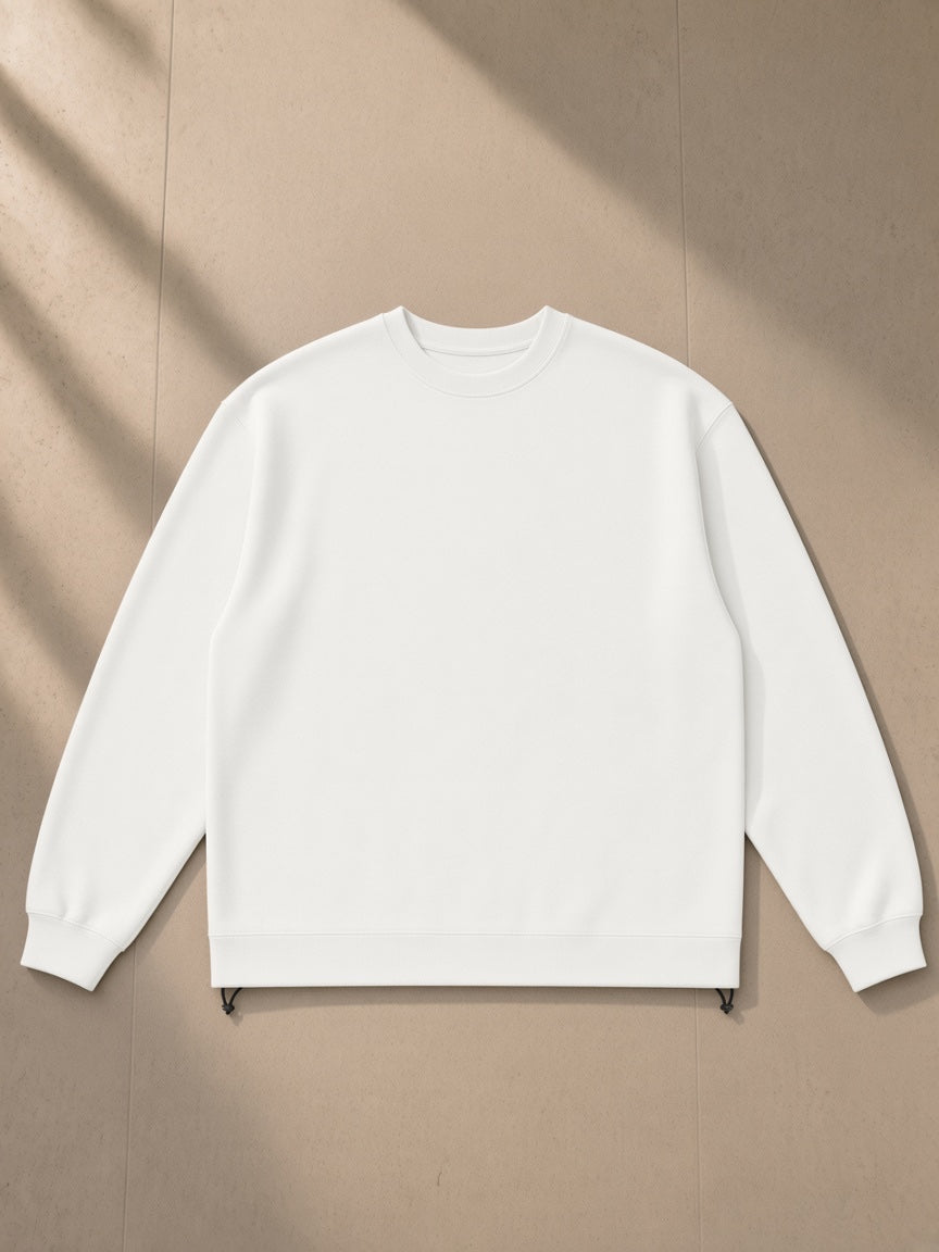 Heavyweight oversized boxy sweatshirt in White, laid flat on pale limestone, front view