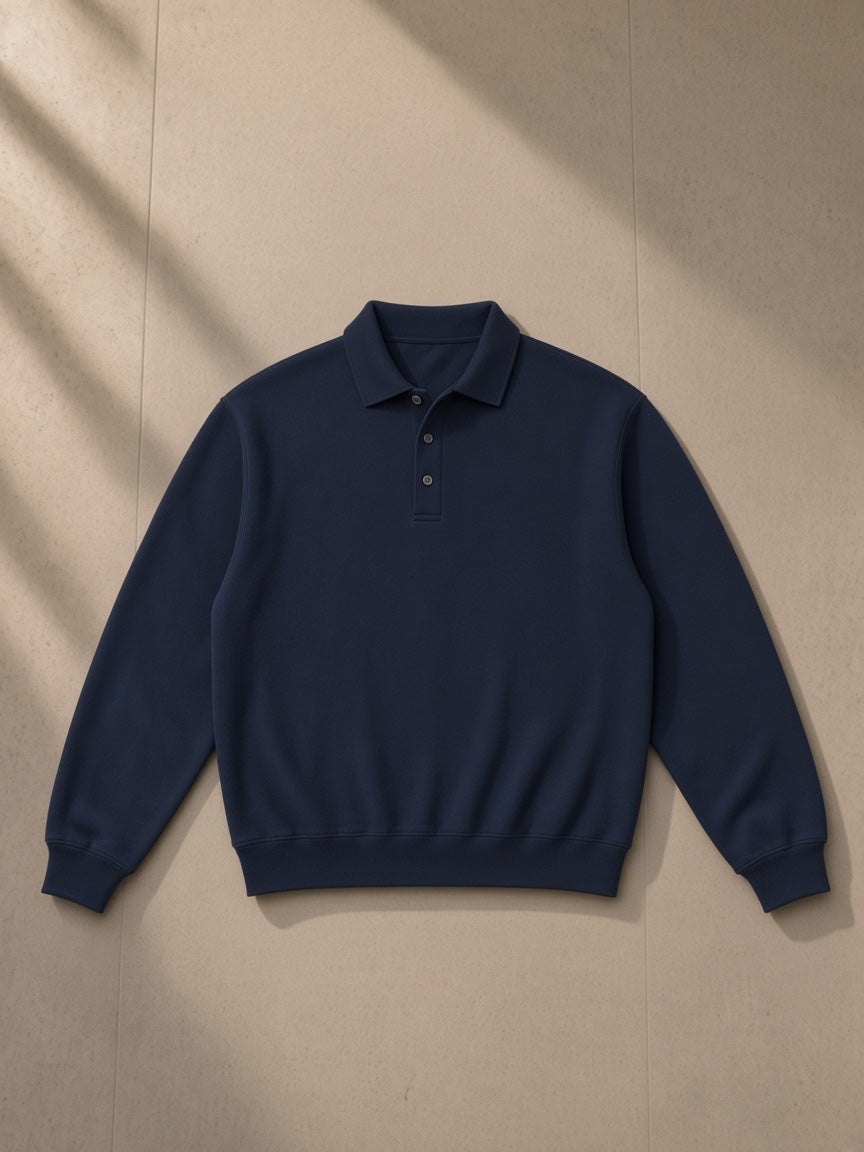 Heavyweight polo-collar sweatshirt in Dark Blue, laid flat on pale limestone, front view