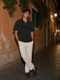 Man in the Heavyweight Snow-Washed Polo in Black on a cobbled street in Rome at night