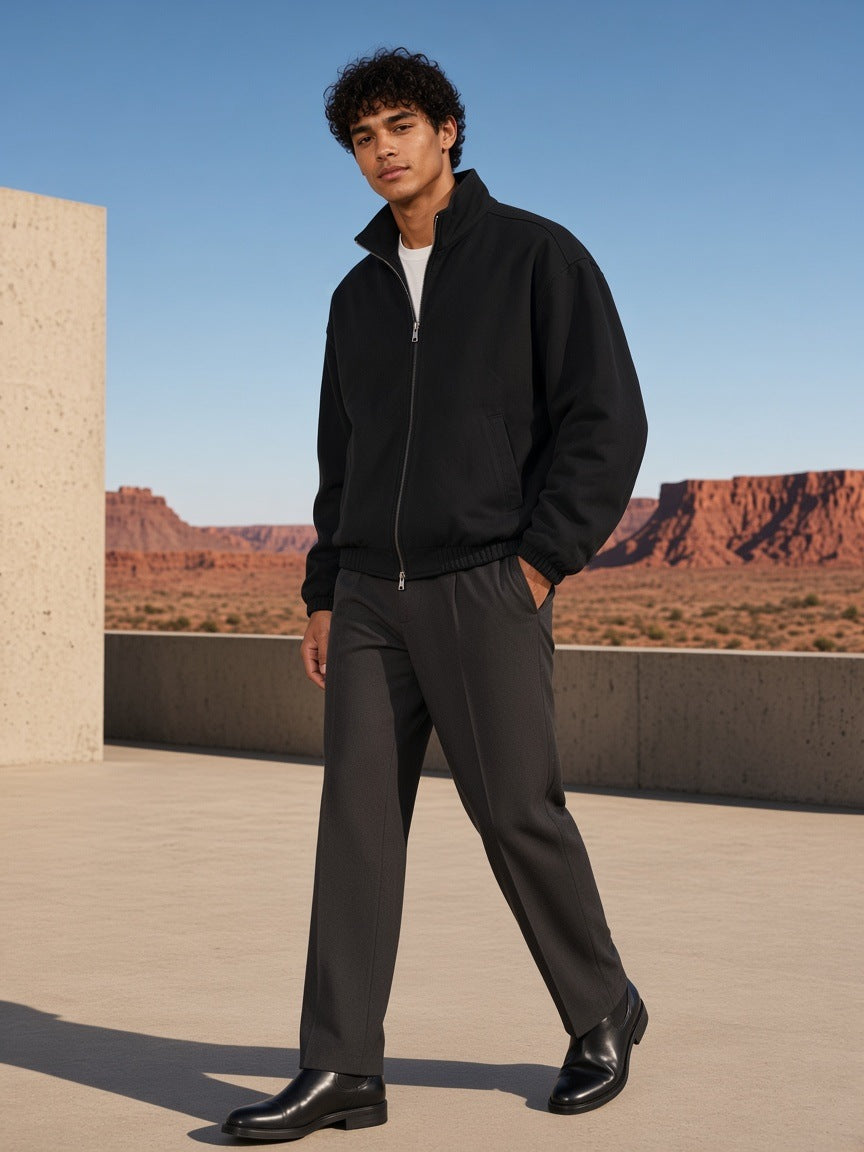 Man in the Heavyweight Stand Collar Jacket in Black, in a concrete courtyard facing the Utah canyonlands in the morning