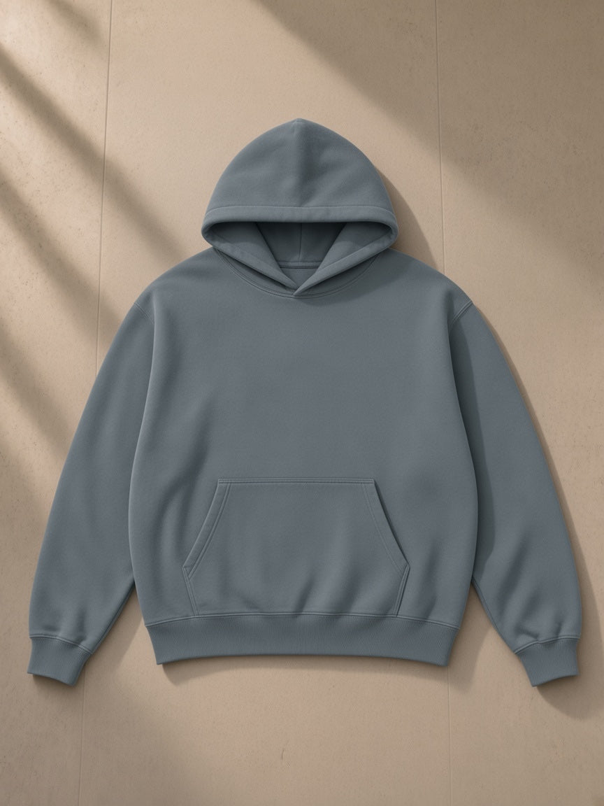 Heavyweight Vintage Wash Boxy Hoodie in Haze Blue, laid flat on pale limestone, front view
