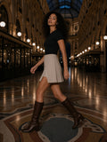 Woman in the High-Waist Pocketed A-Line Skirt in Light Coffee walking across the Galleria Vittorio Emanuele in Milan at night