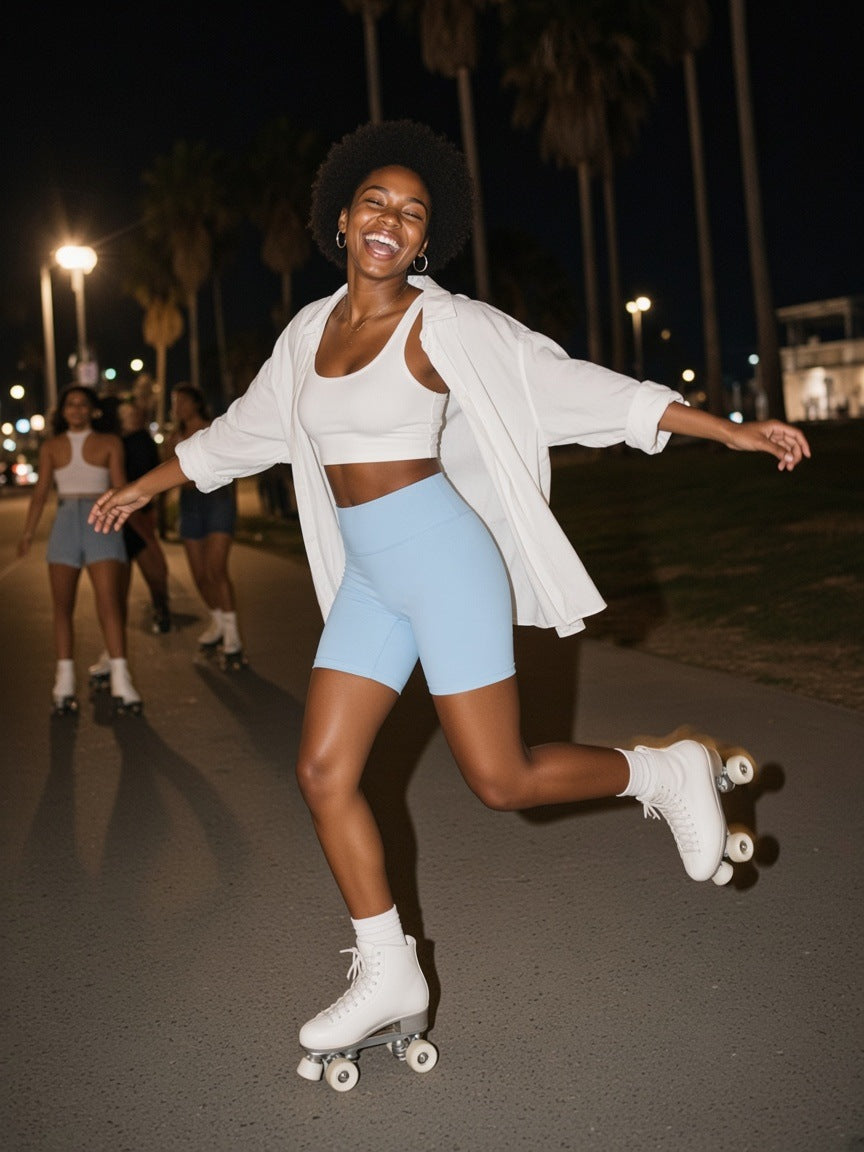 Woman in the High-Waisted Blend Biker Shorts in Sky Blue, rollerskating the Venice Beach path at 1am