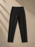 High-Waisted Yoga Leggings in Black, laid flat on pale limestone