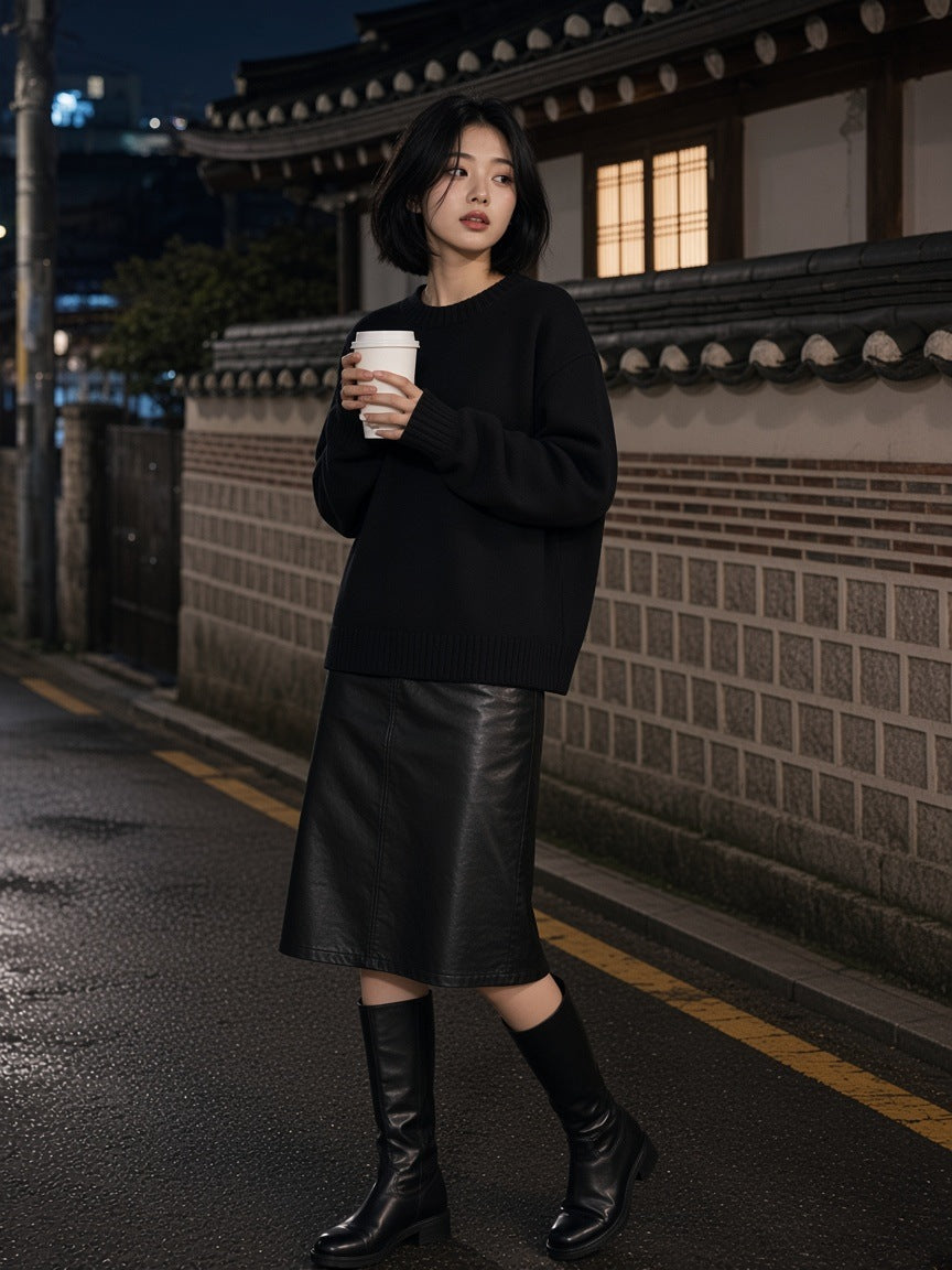 Woman in the Marcel Afters Knitted Round Neck Oversize Sweatshirt in Black on a hanok lane in Seoul at night