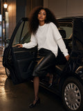 Woman in the Layered Oversized T-Shirt in White tucked into a black leather midi with sheer tights and patent Mary Janes, stepping out of a taxi on a Ginza side street at 1am
