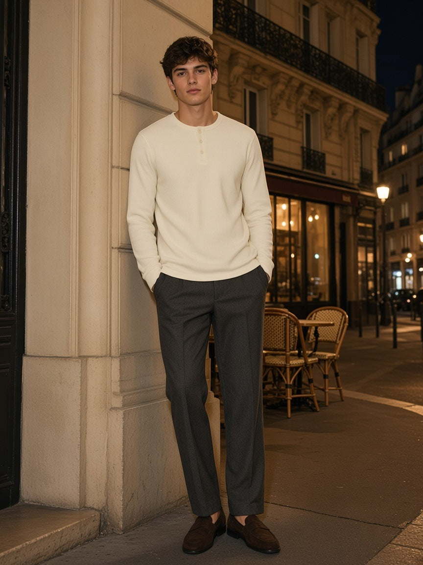 Man in the Long Sleeve Henley T-Shirt in Light Apricot leaning in a limestone doorway on a Paris street at night
