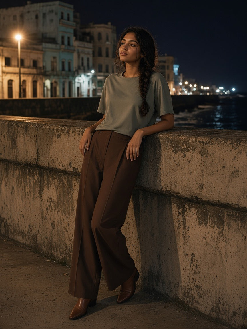 Woman in the Marcel Afters loose drop shoulder t-shirt in Gray Coffee standing on Marine Drive in Mumbai at night
