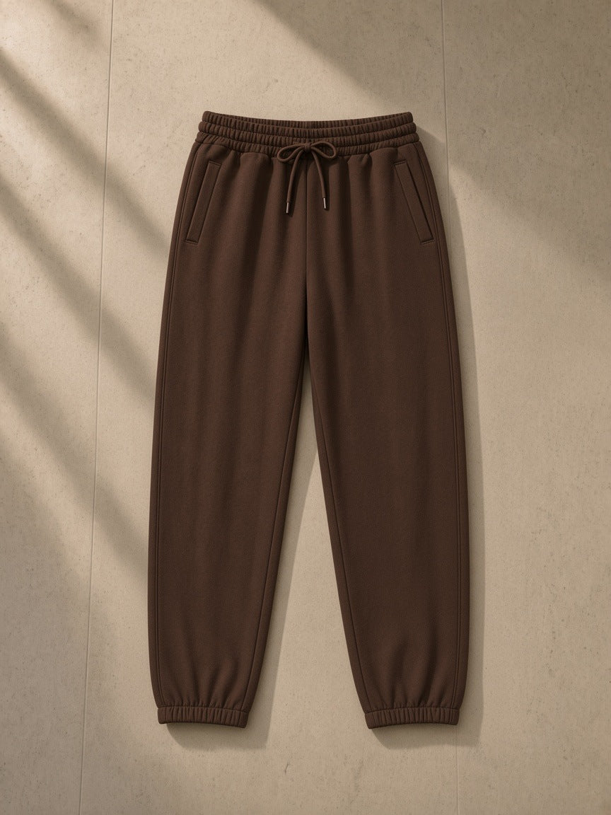 Loose Fit Tapered Joggers in Coffee, laid flat on pale limestone, tapered leg with elastic ankle cuffs