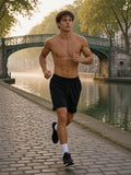 Man in the Loose Raw Edge Shorts in Black, shirtless, jogging along the Canal Saint-Martin at dawn