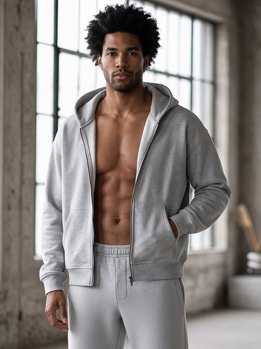 Man in a Flower Gray heavyweight boxy full-zip hoodie worn open, in a loft