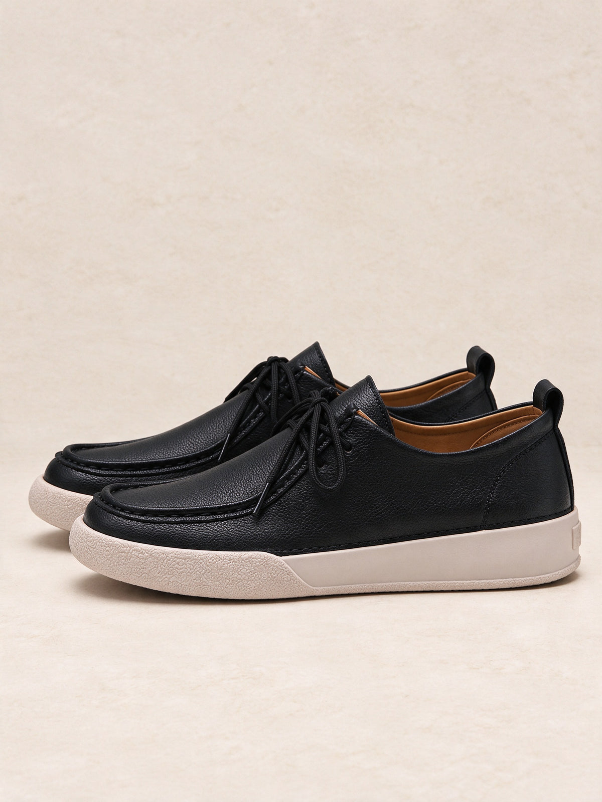 The Afterparty Lace-Up in black, three-quarter side view of the pair on a limestone floor