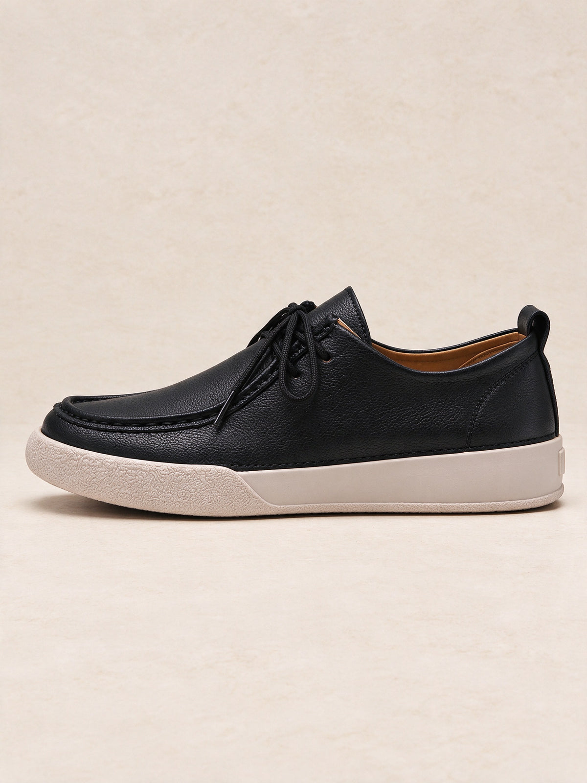 The Afterparty Lace-Up in black, side profile showing the cream sole and moc-toe stitching