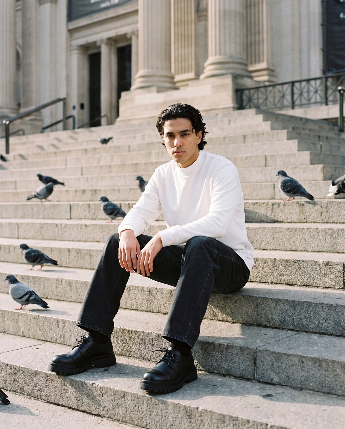 Man wearing The Cab Rank Derby with the Mock Neck Sweatshirt in White, Vintage Wash Straight Leg Jeans in Black. Weekend Uniform, Autumn–Winter 2026 campaign