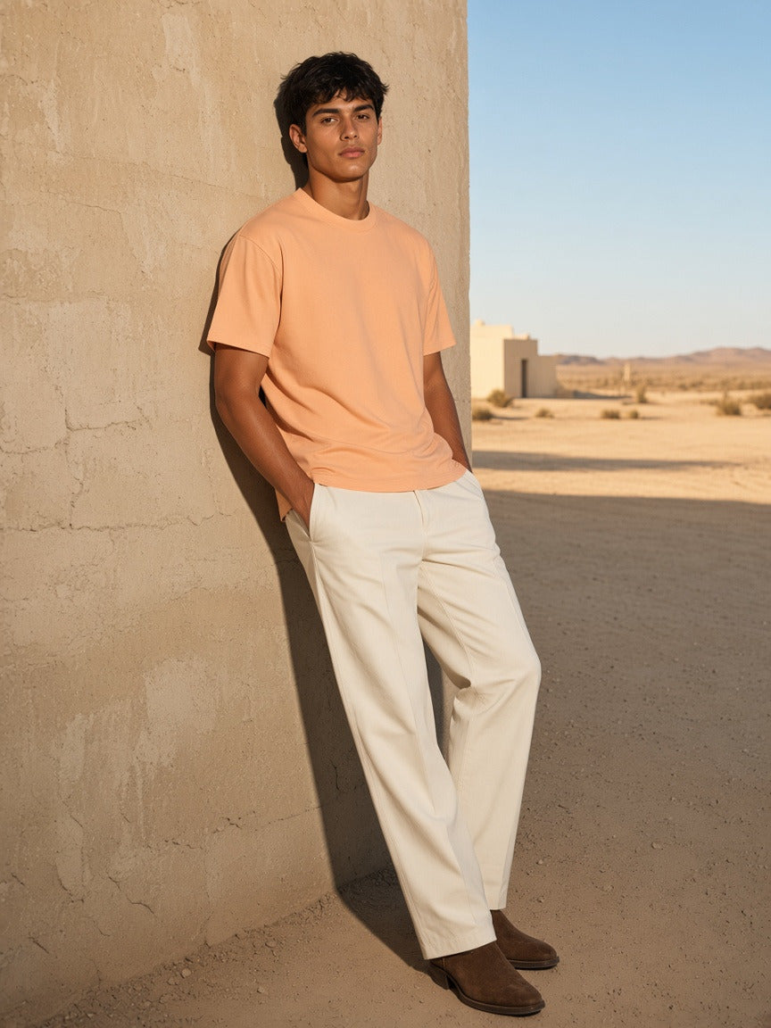Man wearing the Boxy Drop Shoulder T-Shirt in Apricot, full-length model photo