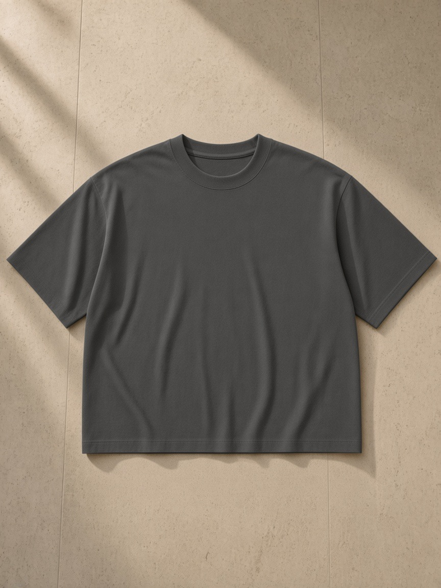 Boxy Oversized T-Shirt in Dark Gray, laid flat on pale limestone