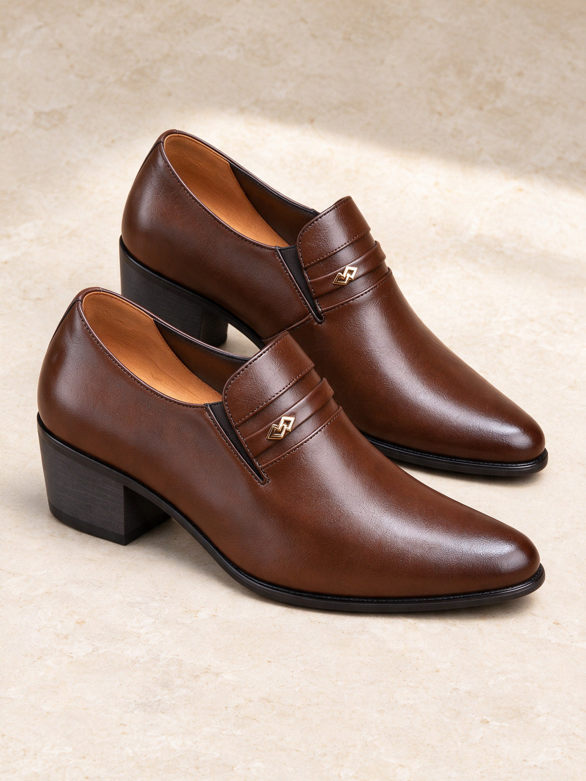 The Aperitivo Loafer in brown, pair on a pale limestone studio floor