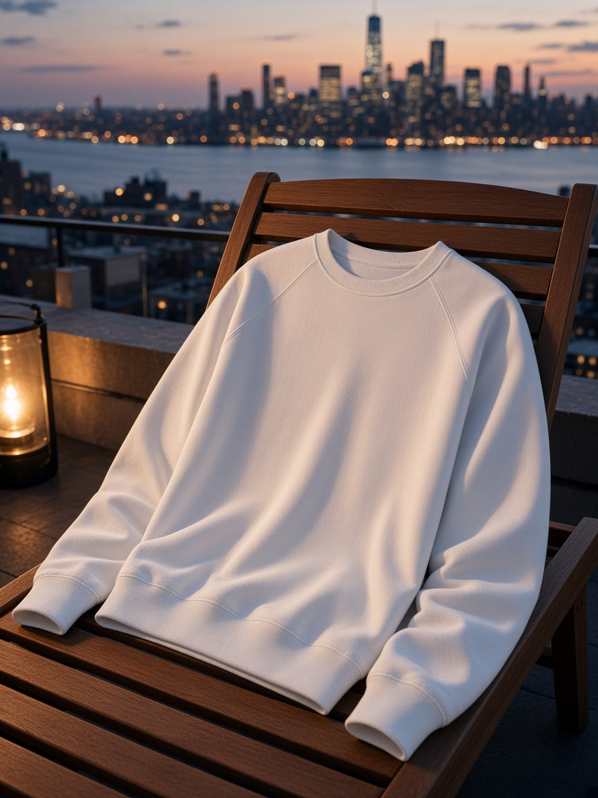 Marcel Afters Classic Cotton Sweatshirt in Lucent White, laid flat, city rooftop at dusk