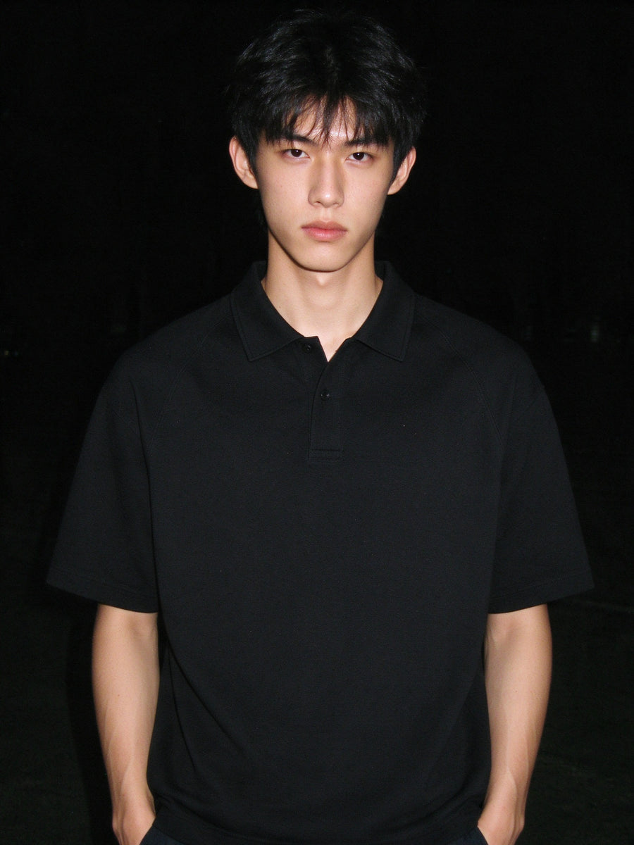 Man wearing the Classic Knit Polo in Black, full-length model photo