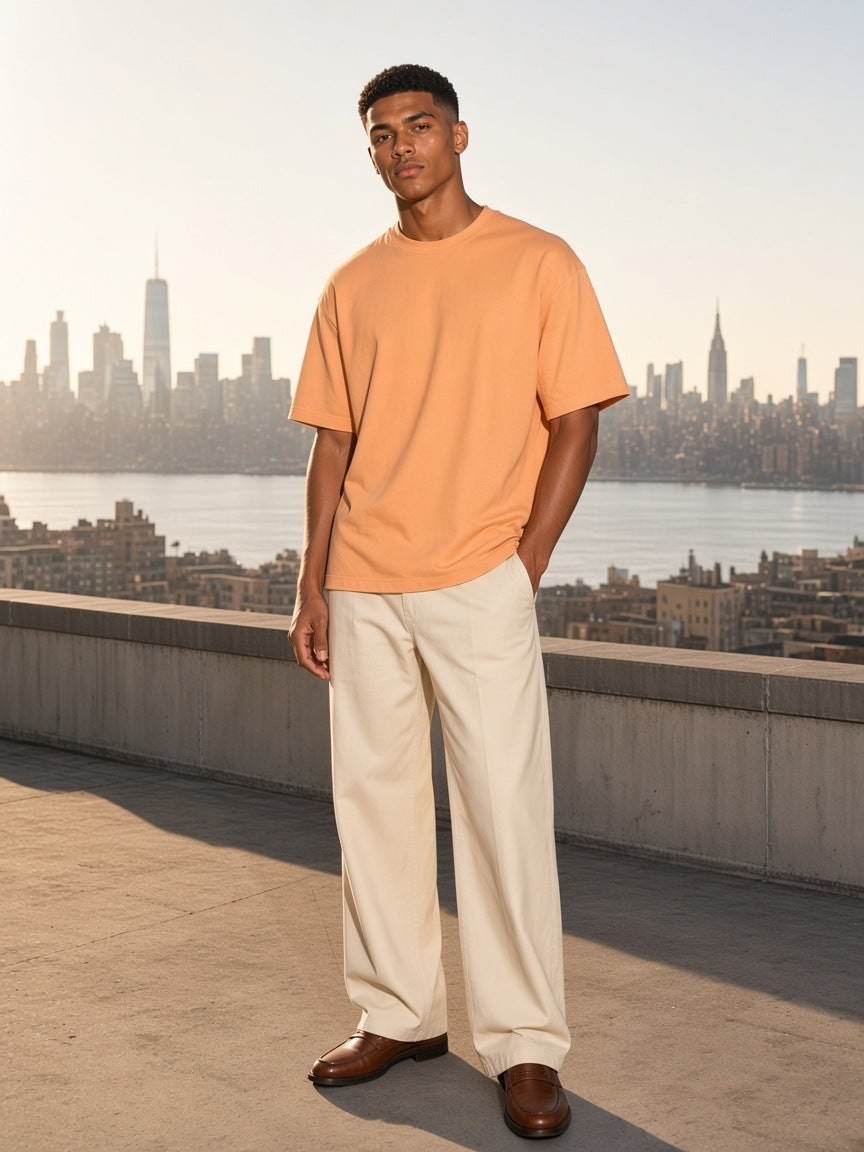 Marcel Afters Classic Loose Boxy Tee in Apricot, worn by a man, city rooftop
