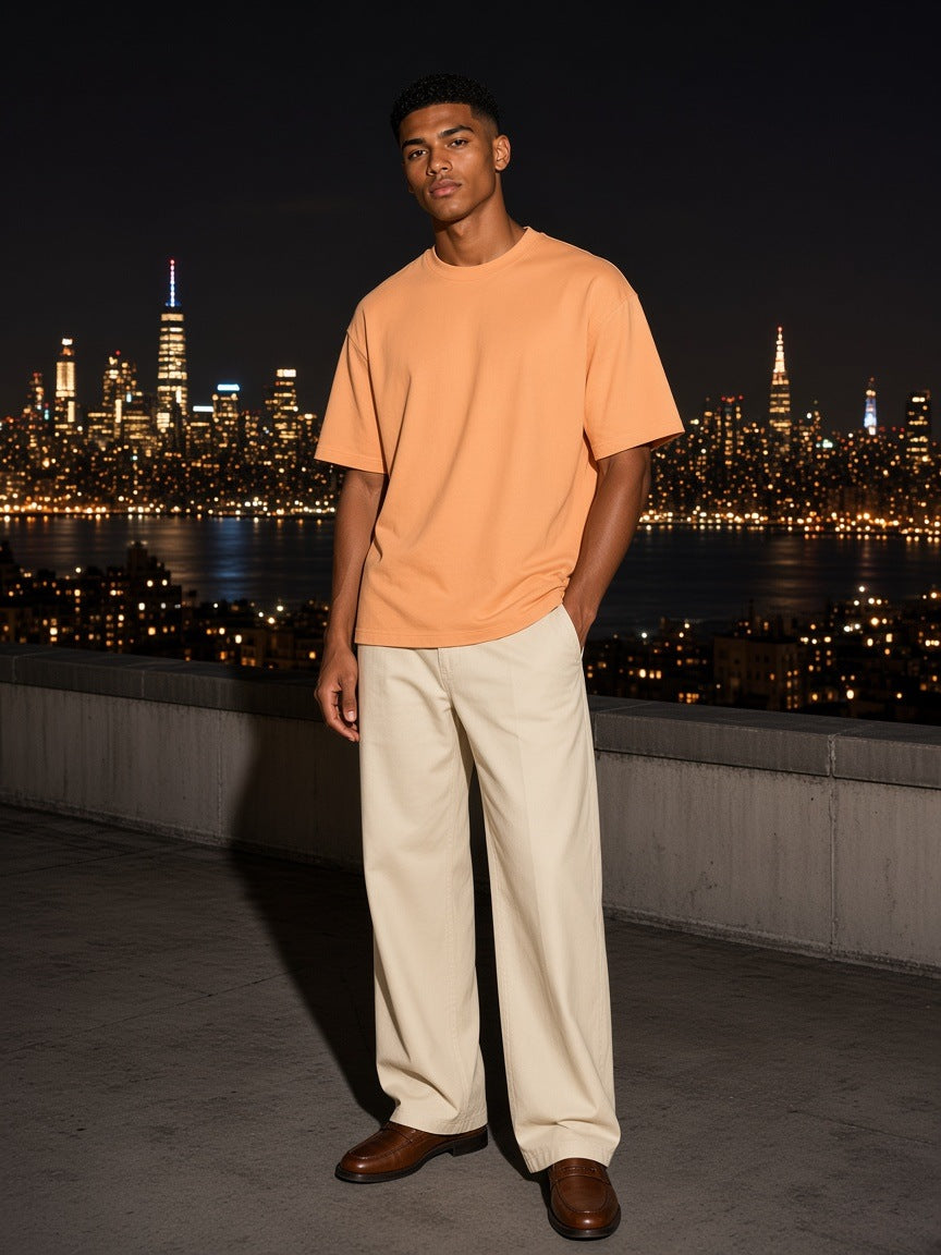 Marcel Afters Classic Loose Boxy Tee in Apricot, worn by a man, city